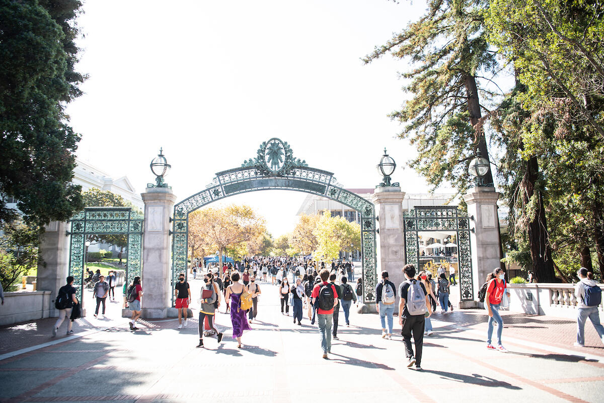 Decorative: People moving under Sather Gate